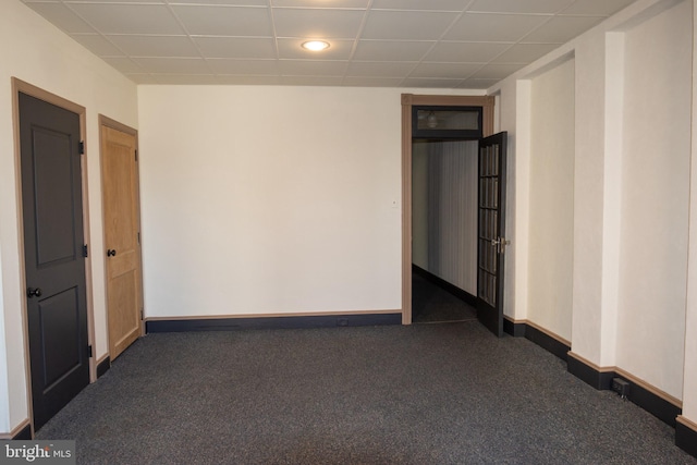 empty room featuring dark colored carpet