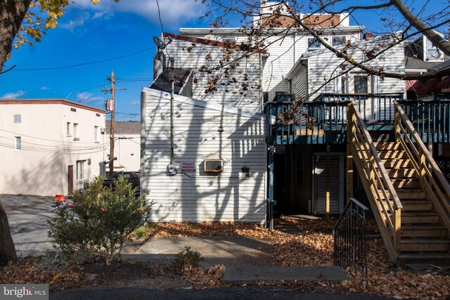 view of side of home with a wooden deck