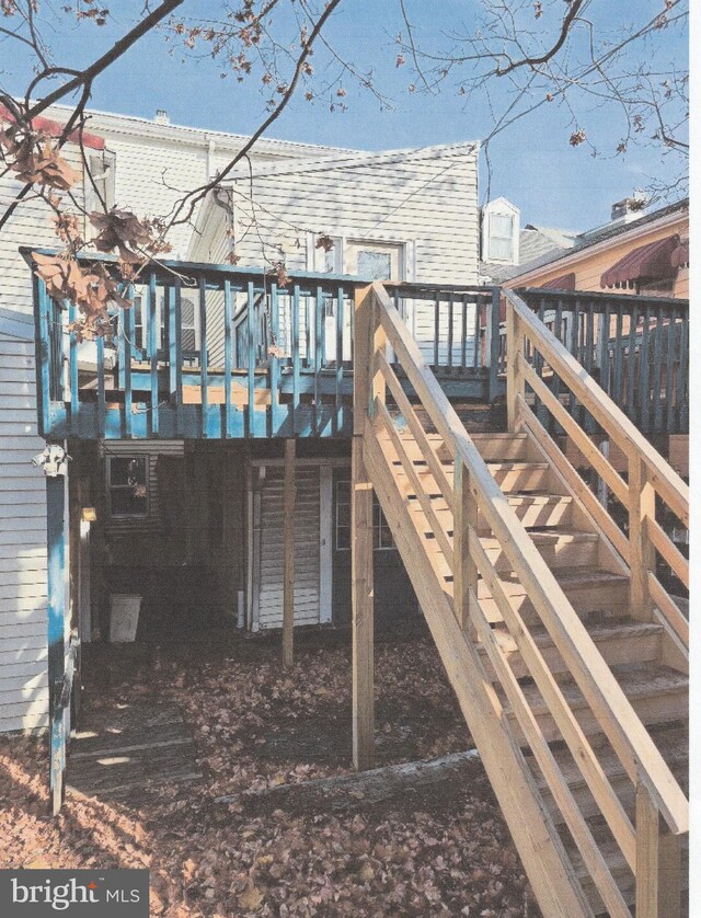 back of house featuring a deck