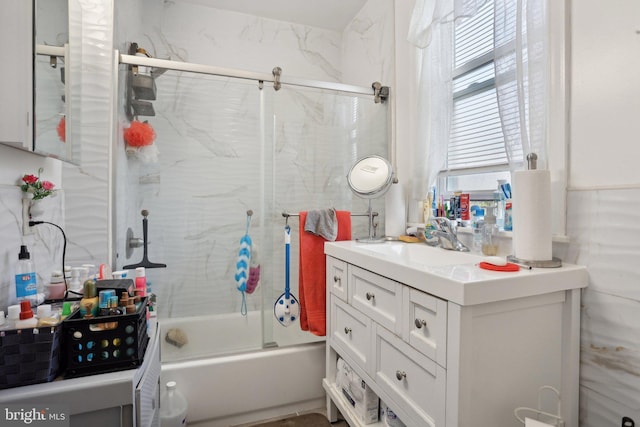 bathroom featuring vanity and combined bath / shower with glass door