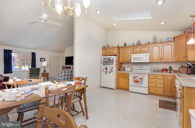 kitchen featuring ceiling fan with notable chandelier, white appliances, hanging light fixtures, and a skylight