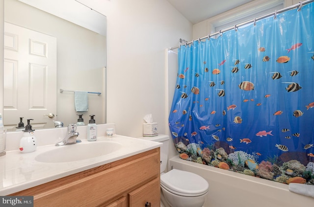 full bathroom with vanity, shower / tub combo, and toilet