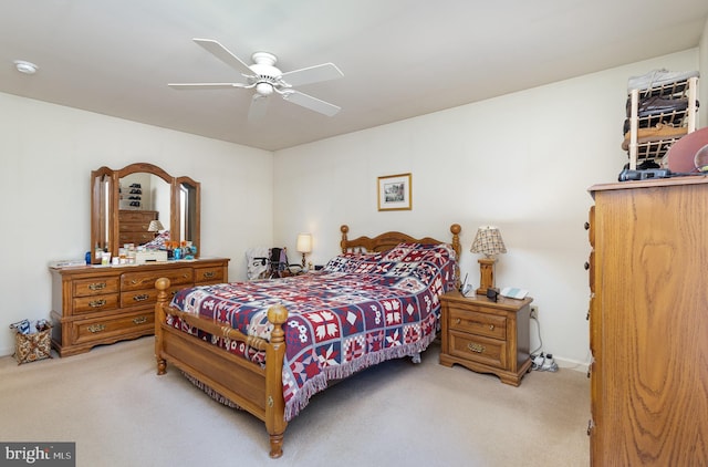 bedroom with light colored carpet and ceiling fan