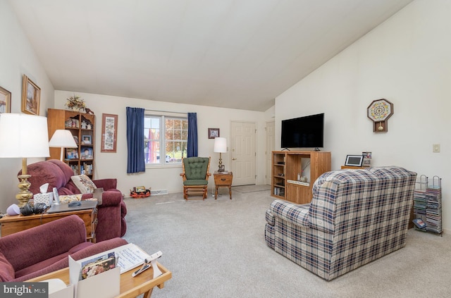 living room with carpet and vaulted ceiling