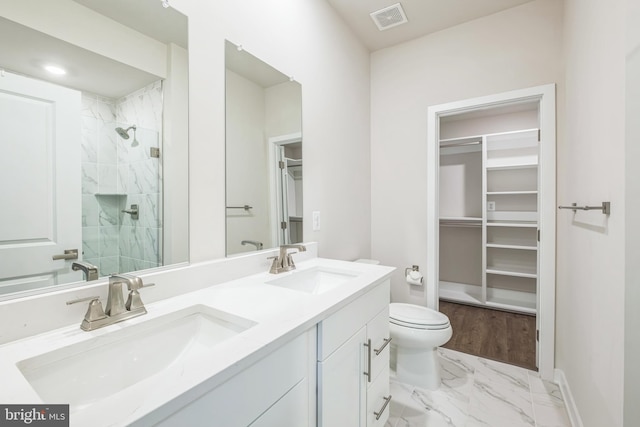 bathroom with vanity, toilet, and an enclosed shower