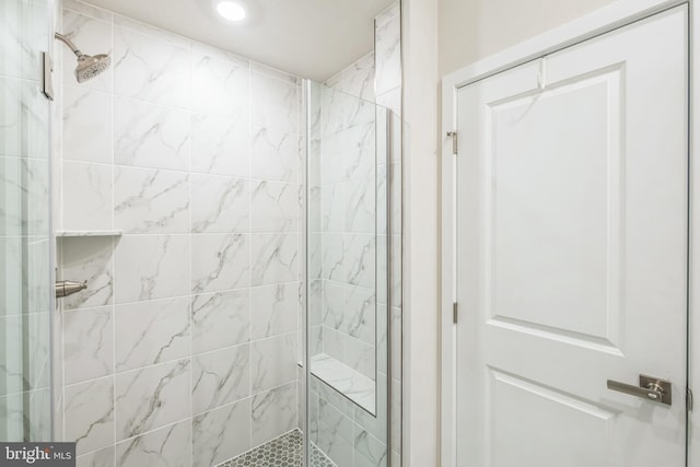 bathroom with a shower with shower door