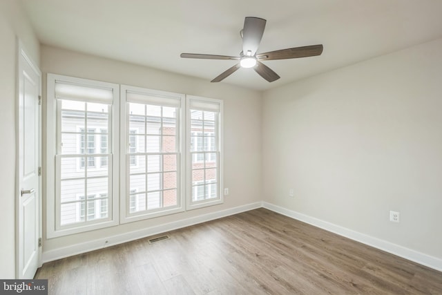 unfurnished room with hardwood / wood-style flooring and ceiling fan