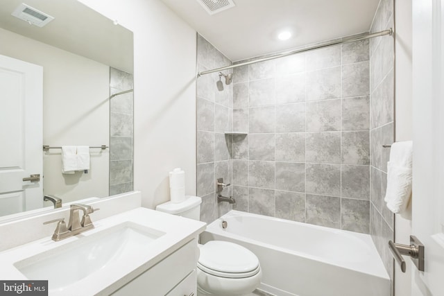 full bathroom featuring toilet, vanity, and tiled shower / bath