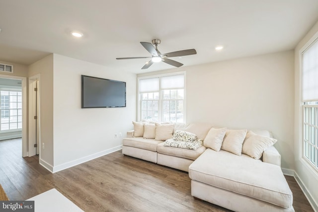 living room featuring hardwood / wood-style flooring and ceiling fan