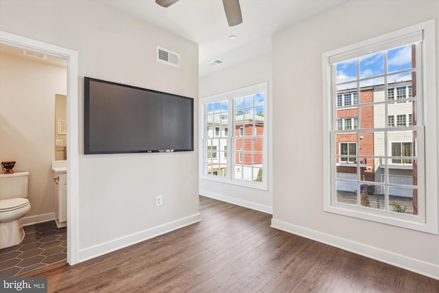 6832 General Davis NW, Washington, DC 20012 - unfurnished bedroom with baseboards, wood finished floors, connected bathroom, and ceiling fan