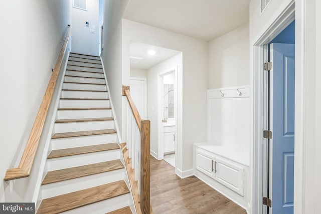 stairway featuring wood-type flooring