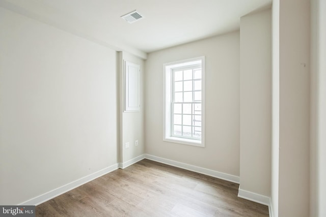 unfurnished room featuring a wealth of natural light and light hardwood / wood-style flooring