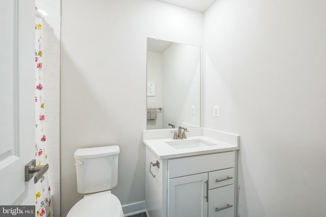 bathroom with toilet and vanity