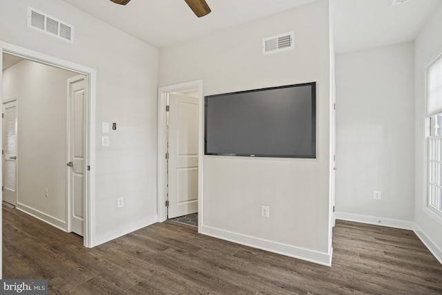 interior space with dark wood-type flooring and ceiling fan