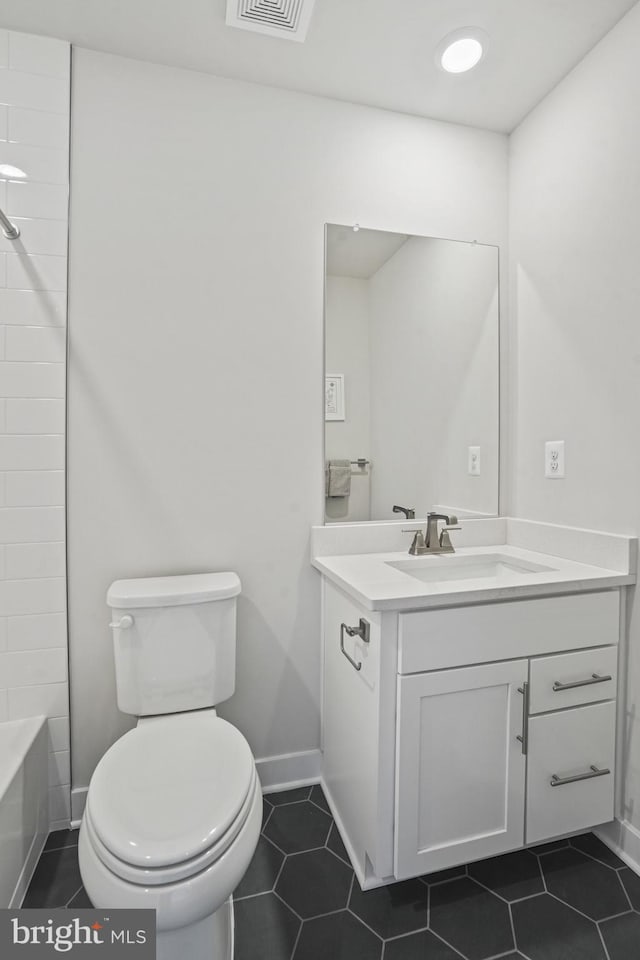 full bathroom featuring washtub / shower combination, toilet, vanity, and tile patterned flooring