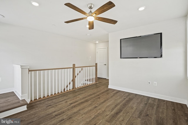 empty room with dark hardwood / wood-style floors and ceiling fan