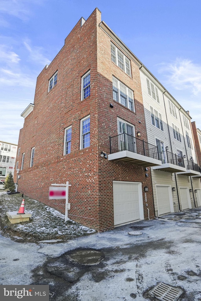 snow covered building with a garage