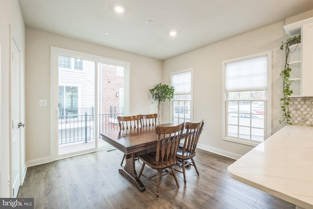 dining space with dark wood-type flooring