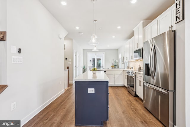 6832 General Davis NW, Washington, DC 20012 - kitchen featuring stainless steel appliances, wood finished floors, white cabinetry, light countertops, and pendant lighting