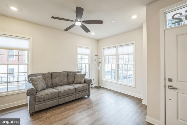 living room featuring hardwood / wood-style flooring and ceiling fan