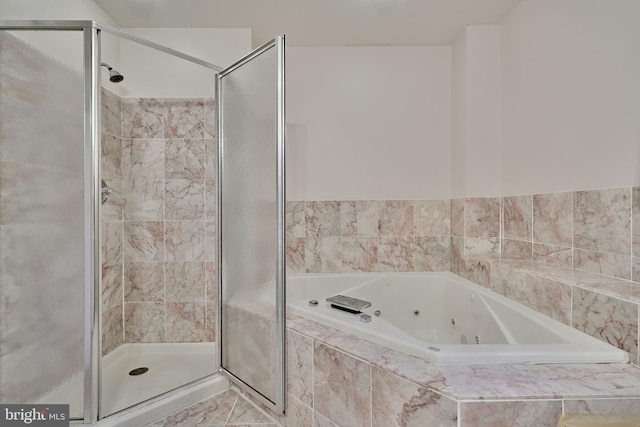 bathroom featuring tile patterned floors and independent shower and bath