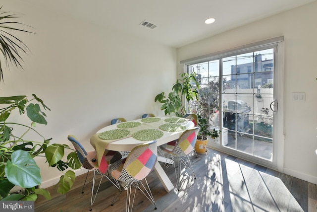 dining area with dark hardwood / wood-style flooring