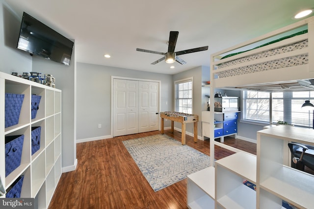 bedroom featuring dark hardwood / wood-style floors, a closet, and ceiling fan