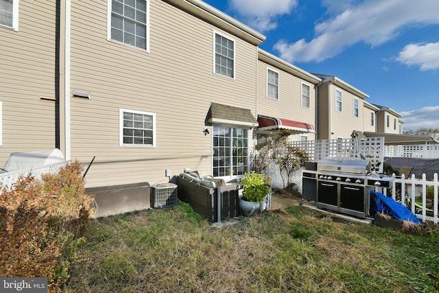 rear view of property with cooling unit