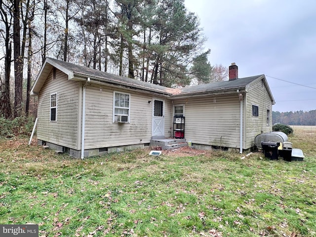 view of front of home with a front yard and cooling unit