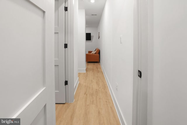 hall with light hardwood / wood-style flooring