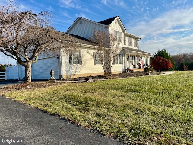 view of front of home with a garage and a front yard