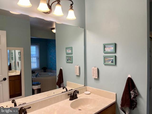 bathroom featuring vanity and a relaxing tiled tub