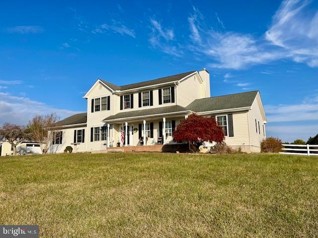 view of front of property with a front lawn and a porch