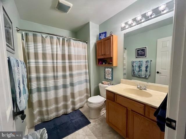 bathroom featuring tile patterned flooring, vanity, and toilet