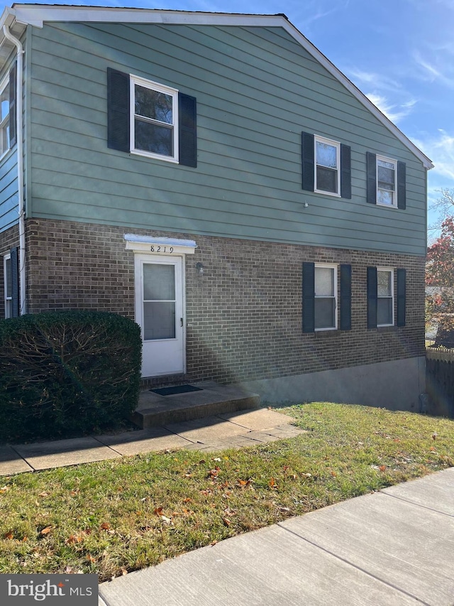 front facade with a front lawn