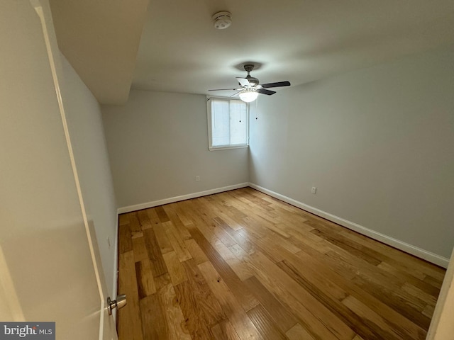 empty room with ceiling fan and light hardwood / wood-style floors