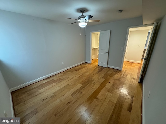 unfurnished bedroom featuring light wood-type flooring and ceiling fan