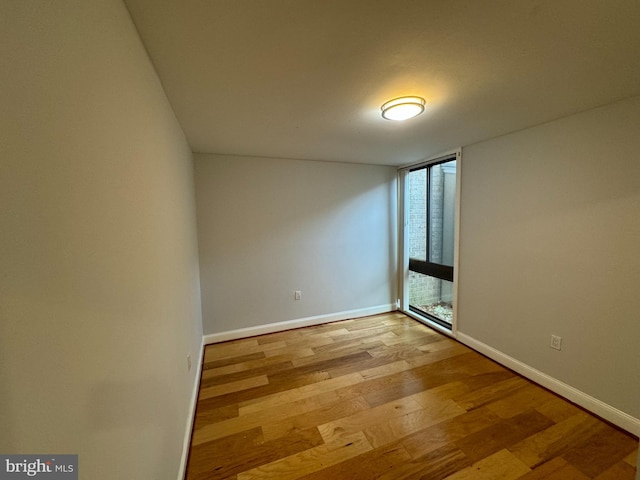 unfurnished room with light wood-type flooring