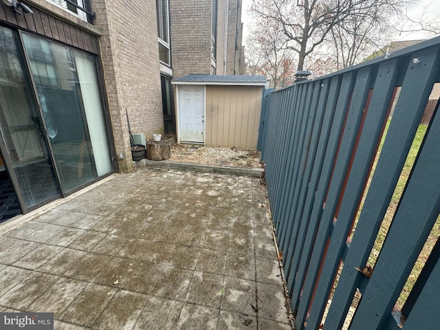 view of patio / terrace with a shed