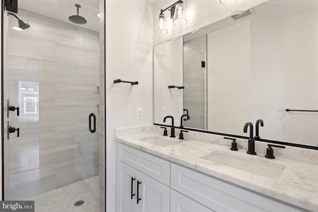 bathroom with an enclosed shower and vanity