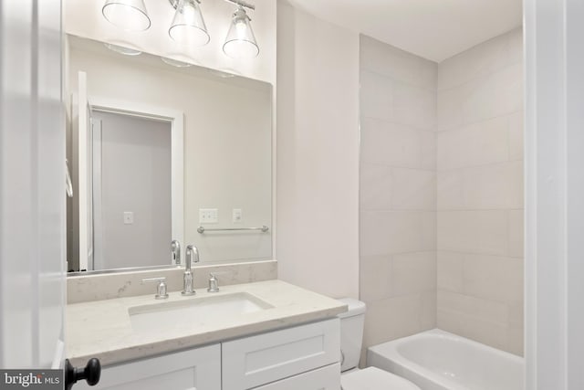 full bathroom featuring toilet, vanity, and washtub / shower combination