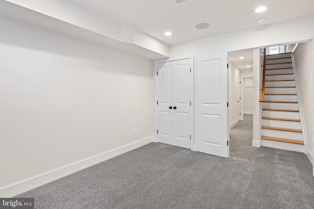 basement with dark colored carpet