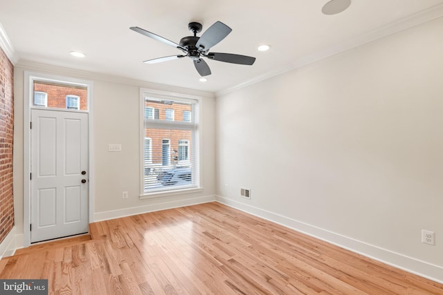 foyer entrance with ceiling fan, ornamental molding, and light hardwood / wood-style floors