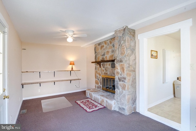 unfurnished living room featuring ceiling fan, carpet, and a fireplace