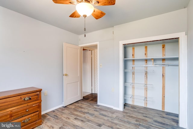 unfurnished bedroom with light hardwood / wood-style floors, a closet, and ceiling fan