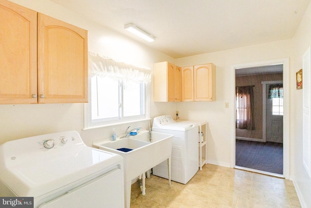 washroom with cabinets and washing machine and clothes dryer