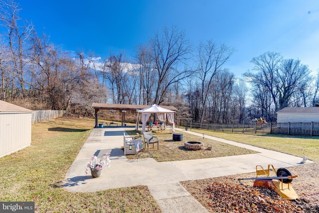 view of yard with a gazebo, an outdoor fire pit, and a patio area