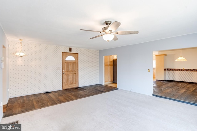 unfurnished room with ceiling fan and wood-type flooring