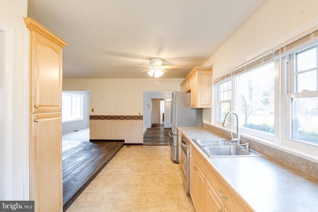 kitchen featuring light brown cabinetry, sink, plenty of natural light, and appliances with stainless steel finishes