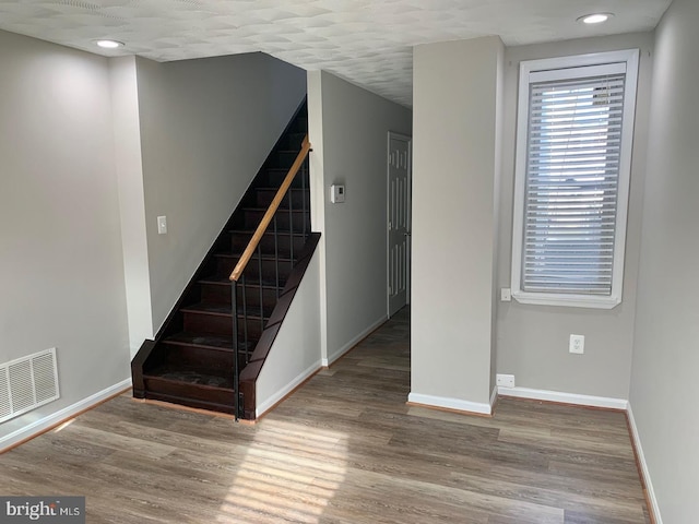 staircase with wood-type flooring